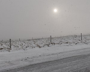 A photo of a snowy road.