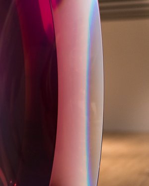 A closeup of a translucent dark red and violet object.