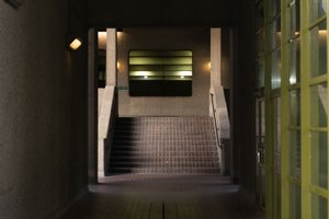 A dark photo looking down a tunnnel in the Barbican.