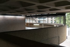 The side of a curved covered walkway in the Barbican.