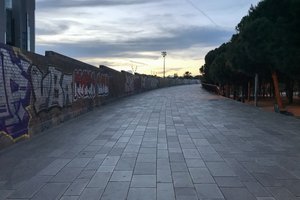 A photo of wide pavement / walkway that rises slightly.