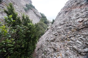 A view down a cut v in two rock faces. Both faces are very steep.