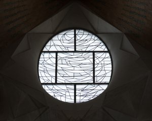 A patterned glass window in la Sagrada Família. It looks similar to an abstract stained glass window, but with frosty white glass.