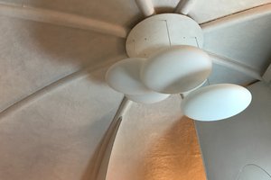 A detail of the center of the ceiling of Futuro house. There are three oval light shades suspended from the ceiling.
