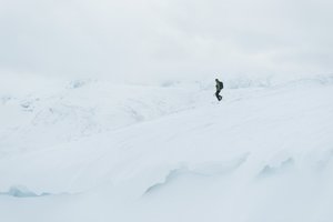 Chris descending a snowy plateau.