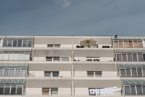 Looking up at a series of concrete balconies on the upper levels of the Brunswick Centre.