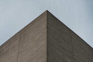 A close detail photo of the upper square corner of one part of the National Theatre’s roof.