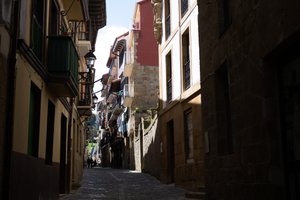 A narrow street in Getaria, with sunlight on one side.