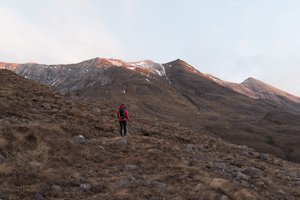 Chris walking away from the camera and towards Beinn Eighe, just at sunrise.