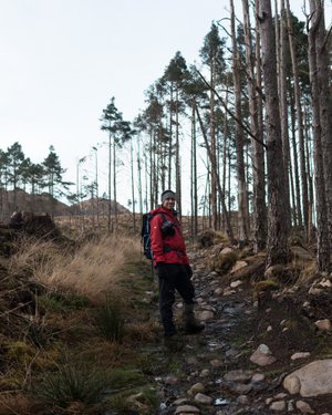 Chris stands facing the camera in a bright red jacket.