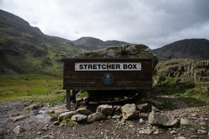 Facing straight on to a wooden box with a large sign in uppercase that reads: “Stretcher box”.