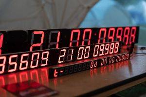 Three rows of red seven segment displays one behind the other make three highly precise clocks.