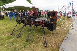 Person riding a giant mechanical robot with 8 legs