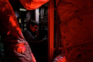 Harry Tuttle uses pliers on some machinery.