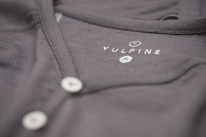 Macro photo of the clothing label in a grey jersey.